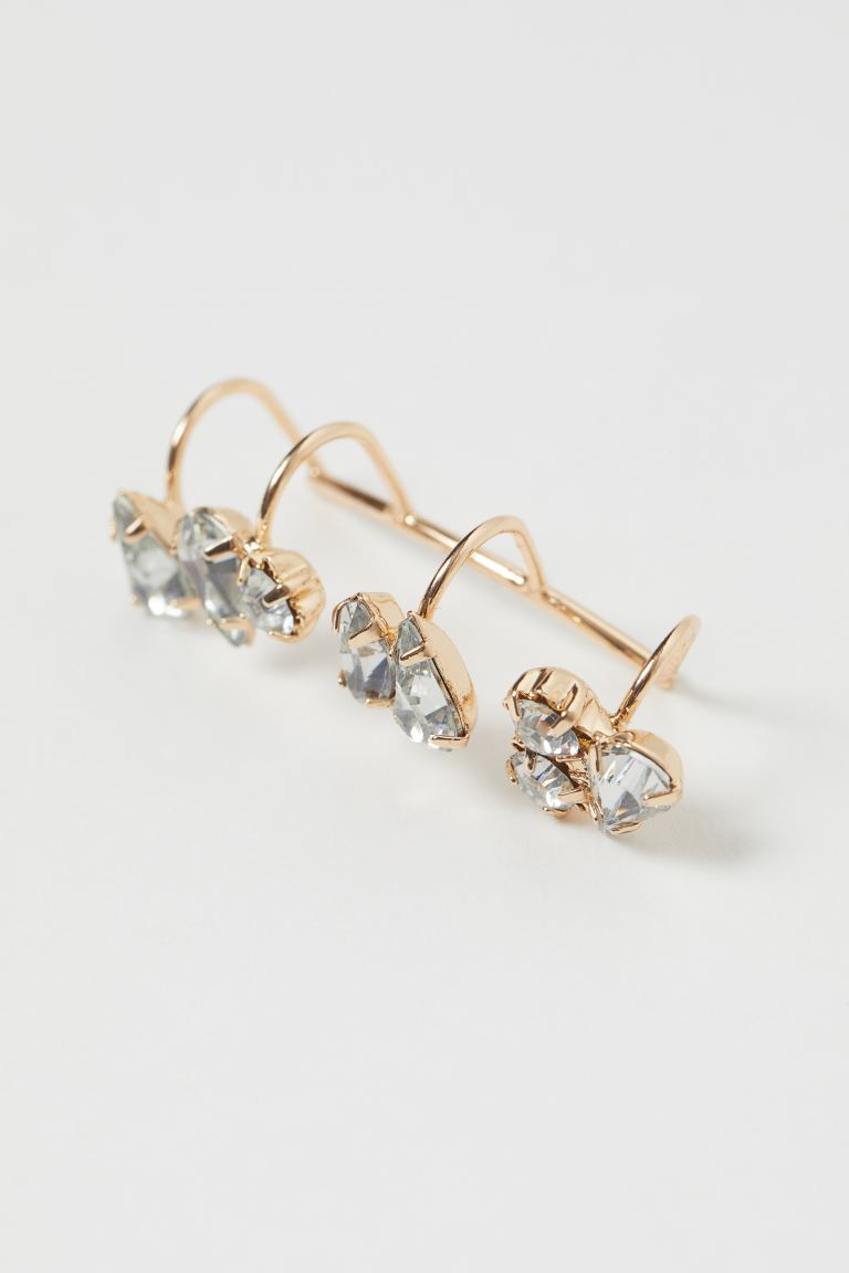 Ear cuff in metal decorated with plastic rhinestones